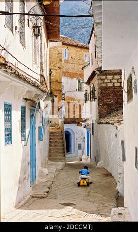 Streets and alleys of the Medina of Chefchaouen, Morocco. A child is playing on the street