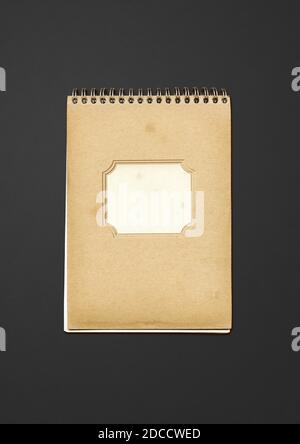 Vintage spiral close notebook, brown paper cover, isolated on black Stock Photo