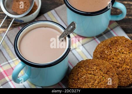 Two hot cocoa drink and oatmeal cookies on the table. Close up Stock Photo
