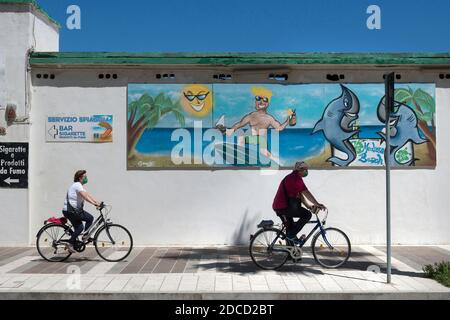 Termoli (CB), Molise Region, Italy: Inhabitants of Termoli on bicycles, stroll along the seafront of the bathing establishments during the lokdown day Stock Photo