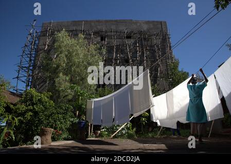 Lalibela/Ethiopia - April 12, 2019: Woman hangs white sheets out to dry Stock Photo