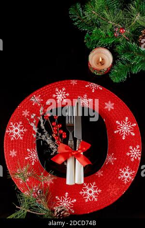 Festive table setting for christmas dinner on black background. Holiday Christmas decorations. Top view. Stock Photo