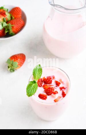 Jug of fresh milk on light blue background Stock Photo - Alamy