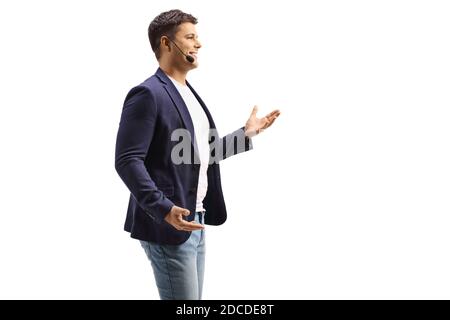 Young man with a wireless microphone isolated on white background Stock Photo