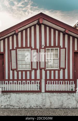 Tradittional fishermen's colorful houses in Costa Nova, Aveiro, Portugal. Tourism atraction. Red stripes Stock Photo