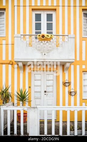 Tradittional fishermen's colorful houses in Costa Nova, Aveiro, Portugal. Tourism atraction. Yellow stripes. Detail of window. Stock Photo