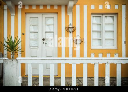 Tradittional fishermen's colorful houses in Costa Nova, Aveiro, Portugal. Tourism atraction. Yellow stripes. Detail of window. Stock Photo