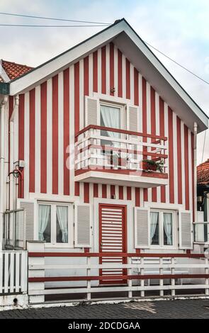 Tradittional fishermen's colorful houses in Costa Nova, Aveiro, Portugal. Tourism atraction. Red stripes Stock Photo