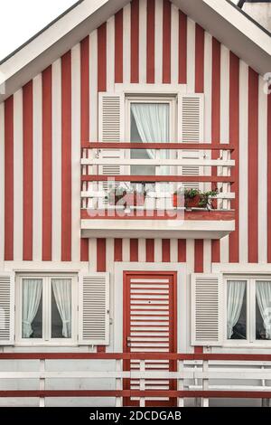 Tradittional fishermen's colorful houses in Costa Nova, Aveiro, Portugal. Tourism atraction. Red stripes Stock Photo