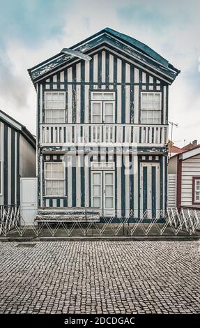 Tradittional fishermen's colorful houses in Costa Nova, Aveiro, Portugal. Tourism atraction. Blue stripes Stock Photo