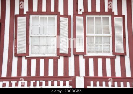 Tradittional fishermen's colorful houses in Costa Nova, Aveiro, Portugal. Tourism atraction. Red stripes. Detail of windows Stock Photo