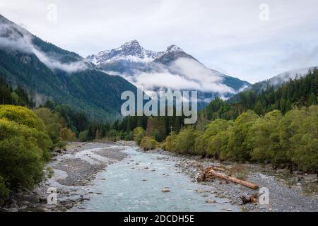 Silvretta Alps surrounding the village of Ramosch (Val Sinestra, Graubünden, Switzerland). It lies in the Lower Engadin valley along the Inn River Stock Photo