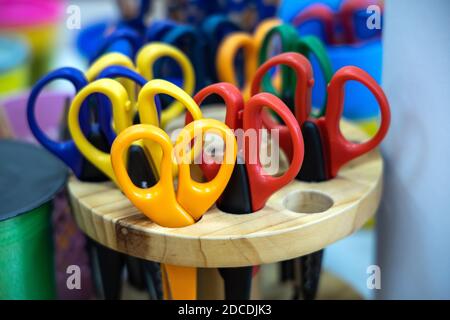 box of colored scissors in an elementary classroom or kindergarten Stock Photo