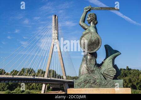 Mermaid statue on Vistulan Boulevards and Swietokrzyski Bridge over Vistula River bank in Warsaw city, Poland Stock Photo