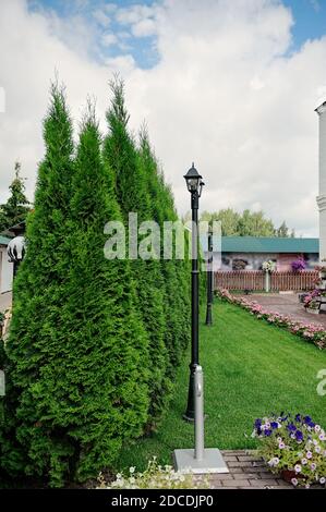 Decorative Small Garden Lamp, Lanterns On A Flowerbed In Green Foliage. garden design. Led Lamps Led Lamps. Stock Photo