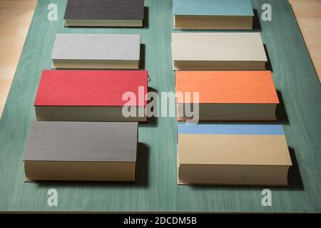 Overhead view of a stack of different hardcover books in a row with perspective. Stock Photo