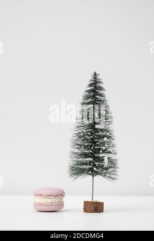 Macaroons or macarons and Christmas tree on a white background. Congratulations to the holidays. Minimalistic concept Stock Photo
