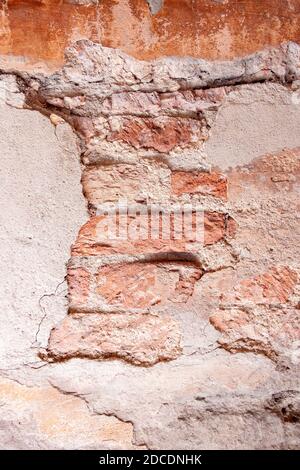 A vertical shot of brick wall with visible mortar between bricks Stock Photo