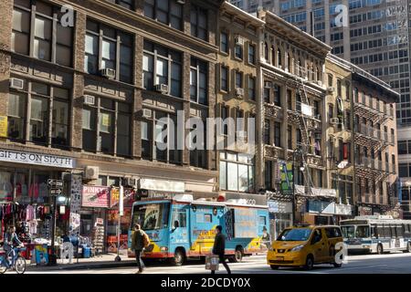 Business facades along Sixth Avenue in the garment district, Manhattan, NYC, USA Stock Photo