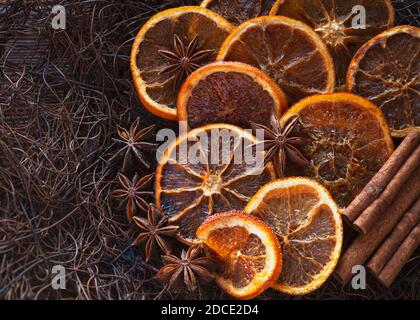 bright vibrant christmas food background,  top view of sliced dried oranges with spices  copy space to side Stock Photo
