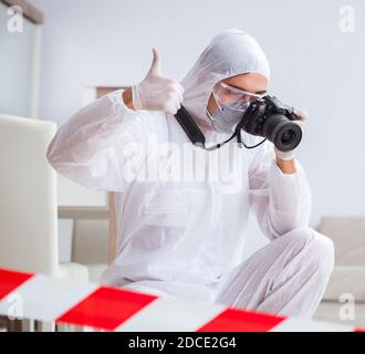 The forensic expert at crime scene doing investigation Stock Photo