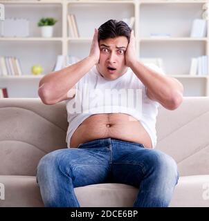 The man suffering from extra weight in diet concept Stock Photo