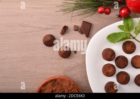 Christmas composition with chocolate truffles on wooden table with ribbon. Top view. Horizontal composition. Stock Photo