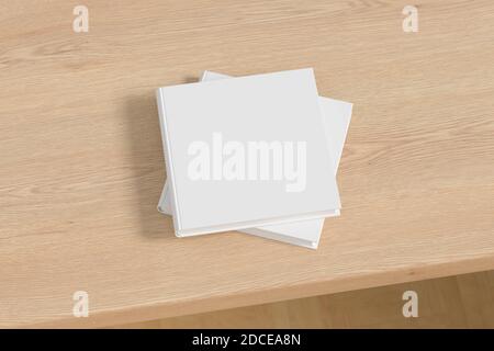 Square white hardcover book stack mockup on the wooden table Stock Photo
