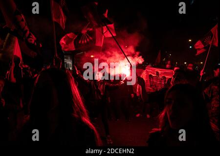 Madrid, Spain. 20th Nov, 2020. Far right wing supporter making a fascist salute carrying a flare during a rally to commemorate the death anniversary of Falange founder Jose Antonio Primo de Rivera. Credit: Marcos del Mazo/Alamy Live News Stock Photo