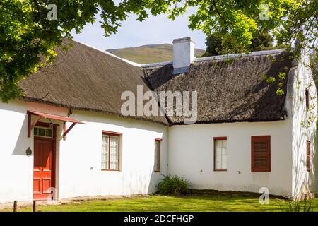 Cape Dutch style cottage with thatched roof in Genadendal, South Africa Stock Photo