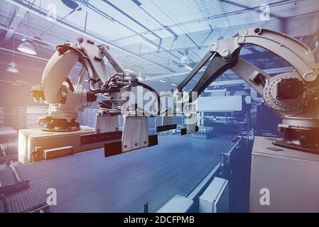 Robot arm manipulator. Modern packaging line for water and beer and drinks warehouse. Automated Industrial Conveyor Forming Line Stock Photo