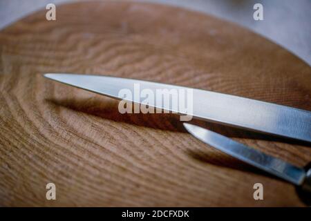 Knives on a wooden cutting board, close up. Stock Photo