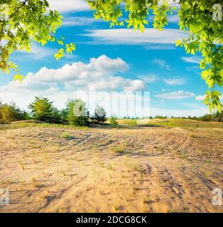 Cloudy sky and sunlight over sandy desert Stock Photo