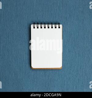 Empty notebook on blue fabric background. top view, copy space Stock Photo