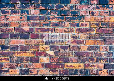 Old, rustic red corroded and damaged brick wall. High quality texture and background for your projects and creative work Stock Photo