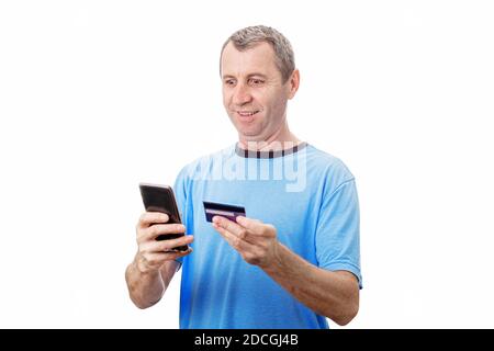 Shocked Middle Aged Man Middle aged man using  mobile phone browse and order products online. People staying home, buying seasonal holiday gifts with Stock Photo