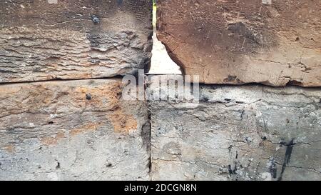 Burnt brick surfaces covered with gray ashes and coal dust. Red and grey charred bricks in old charcoal brazier. Smoky brick textured grunge backgroun Stock Photo