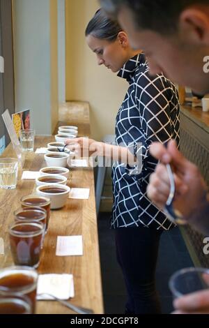 The process of cupping. Tasting freshly brewed coffee with spoons. Coffee accessories on the table Stock Photo