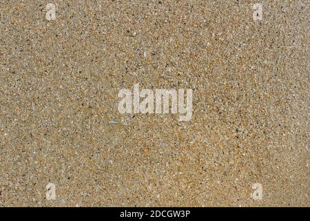 Wet sand on the shore as a background Stock Photo