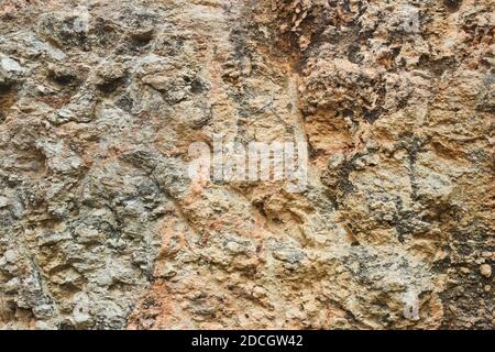 Textured sheer stone wall as background Stock Photo