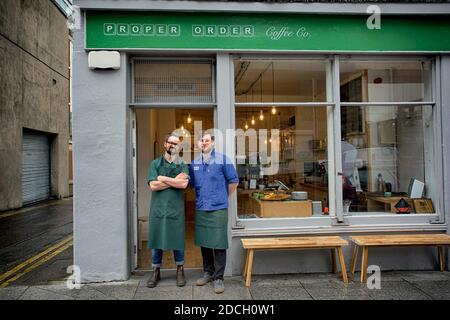 Ireland/Dublin /Coffee Style /Young owners of Proper Order Coffee Co. standing arms crossed In front of the cafe Stock Photo