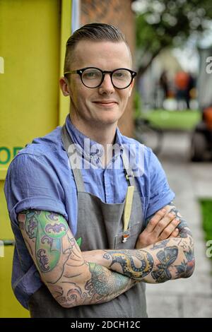 Ireland /Dublin / Coffee Style /Young Owner Standing Arms Crossed In Cafe Stock Photo