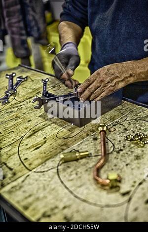 Male employee at the La Marzocco factory working on espresso machine ,Scarperia, Florence ,Italy Stock Photo