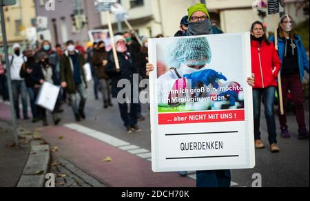 21 November 2020, Baden-Wuerttemberg, Göppingen: ''When I grow up, I want to become a virologist'' is written on the sign of a man who takes part in a demonstration against the Corona policy of the federal government. Photo: Christoph Schmidt/dpa Stock Photo