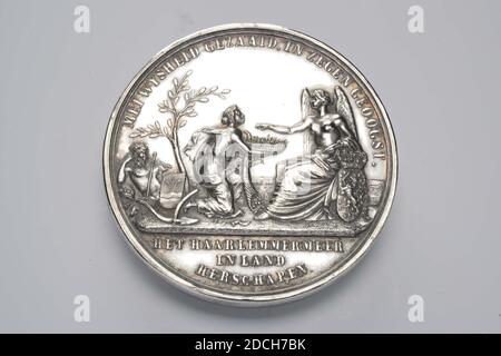 commemorative medal, Moses de Vries jr, 1853, minted, General: 5.1 x 0.4cm 51 x 4mm, Weight: 76.7g, fruit, female, horn of plenty, cup, weapon sign, man, tree, Silver commemorative medal, struck on the reclamation of the Haarlemmermeer, 1853. On the obverse is a kneeling female figure who wears an inverted horn of plenty in the left hand. The female figure offers a sitting, winged woman the Dutch virgin? a basket of fruits. Next to the seated woman, the coat of arms of Holland can be seen a crowned shield with the climbing lion in it. In the left corner of the scene you can see a tree with Stock Photo