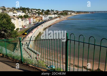 Part of the new seawall at Dawlish, seen from above Boat Cove. The train is 2C47 the 1121 Exeter to Plymouth. Stock Photo