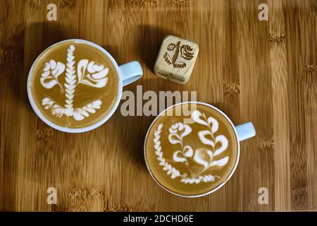 Latte art dice and latte art on wood table