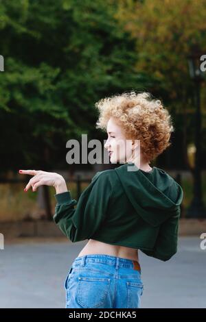 Fashionista girl hipster in green crop top on the street. Trendy urban girl  fashion model outdoors. Casual style. Youth, street style, lifestyle, free  time concept Stock Photo - Alamy