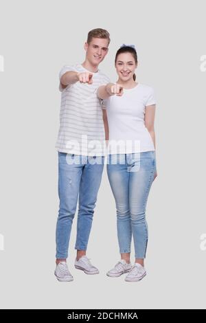 Couple Pointing to Camera Standing Isolated. Man and Woman Pointing, Lovers, Friends, Couple Concept Stock Photo