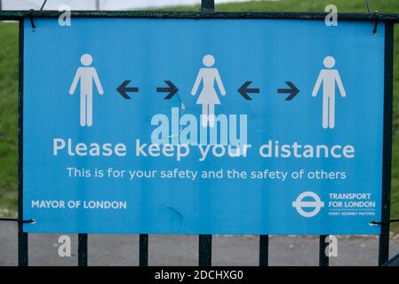 Social distancing sign instructing people to keep their distance due to covid19. Stock Photo